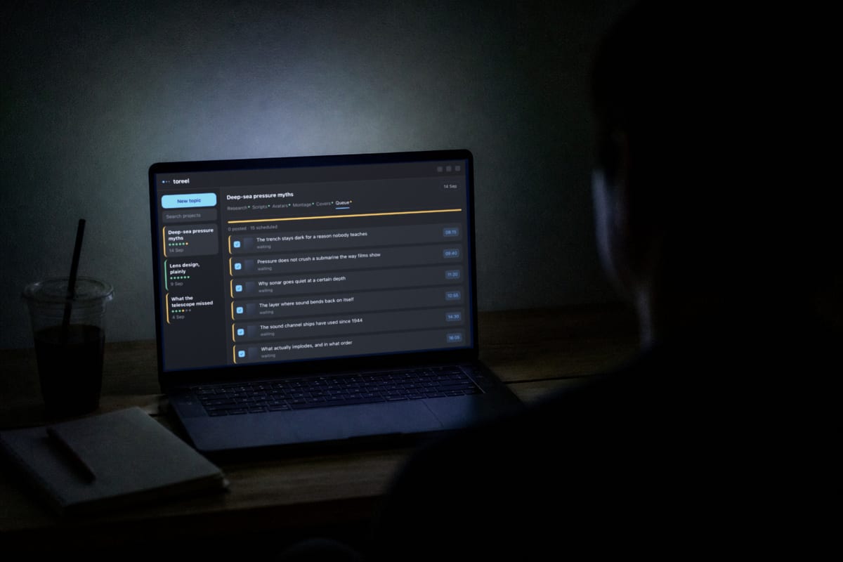 A desk at night lit only by an open laptop